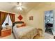 Cozy bedroom with a ceiling fan, side table, and view of an interior space at 2101 S Meridian Rd # 99, Apache Junction, AZ 85120