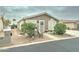 Lovely front exterior showcasing a well-maintained yard with mature plants and a cozy front porch at 2101 S Meridian Rd # 99, Apache Junction, AZ 85120