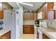 Well-lit kitchen featuring wooden cabinets, modern appliances, and laminate countertops at 2101 S Meridian Rd # 99, Apache Junction, AZ 85120