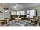 Comfortable living room showcasing a large sectional sofa, cozy rocking chair, and natural light through large windows at 2101 S Meridian Rd # 99, Apache Junction, AZ 85120
