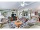Spacious living room featuring neutral decor, comfortable seating, decorative shelving, and a ceiling fan for added comfort at 2101 S Meridian Rd # 99, Apache Junction, AZ 85120