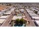 Aerial view of a mobile home community with a pool, mature landscaping and well-maintained streets at 2121 N Center St # 141, Mesa, AZ 85201