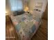 Bright bedroom with colorful patchwork quilt and bedside tables at 2121 N Center St # 141, Mesa, AZ 85201