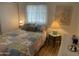 Bright bedroom with colorful patchwork quilt and bedside tables at 2121 N Center St # 141, Mesa, AZ 85201