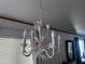 Close-up of a decorative chandelier with flower accents, enhancing the room's charm at 2121 N Center St # 141, Mesa, AZ 85201