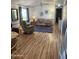 Bright living room offers a recliner, sofa, and smooth flooring at 2121 N Center St # 141, Mesa, AZ 85201