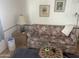 Comfortable living room with floral sofa, area rug, and wood-look flooring at 2121 N Center St # 141, Mesa, AZ 85201