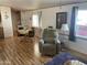 Inviting living room with wood floors, dining area, and lots of natural light at 2121 N Center St # 141, Mesa, AZ 85201