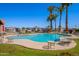 Enjoy the community pool, complete with lounge chairs, tables and palm trees, perfect for relaxation and leisure at 2121 N Center St # 141, Mesa, AZ 85201