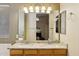 Bathroom featuring double sinks with granite counters and modern vanity lighting at 2123 E Catclaw St, Gilbert, AZ 85296