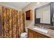 Bathroom with granite countertops and a shower/tub combo with decorative curtain at 2123 E Catclaw St, Gilbert, AZ 85296