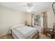 Comfortable bedroom with ceiling fan and large window providing natural light at 2123 E Catclaw St, Gilbert, AZ 85296