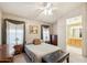 Cozy bedroom featuring a ceiling fan, neutral paint, and traditional furnishings and décor at 2123 E Catclaw St, Gilbert, AZ 85296
