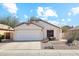 Charming single-story home featuring a two-car garage and low-maintenance desert landscaping at 2123 E Catclaw St, Gilbert, AZ 85296