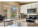 Kitchen featuring stainless steel appliances, granite countertops, and lots of natural light at 2123 E Catclaw St, Gilbert, AZ 85296