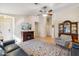 Inviting living room features a fireplace, ceiling fan, and wood flooring at 2123 E Catclaw St, Gilbert, AZ 85296