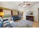 Bright living room with a fireplace, wood floors, and large windows at 2123 E Catclaw St, Gilbert, AZ 85296