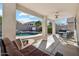 A covered patio showcases the stunning outdoor pool, seating, and backyard at 2123 E Catclaw St, Gilbert, AZ 85296