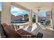 A covered patio showcases the stunning outdoor pool, seating, and backyard at 2123 E Catclaw St, Gilbert, AZ 85296