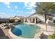 Backyard view of in-ground pool with rock features and outdoor patio furniture at 2123 E Catclaw St, Gilbert, AZ 85296