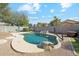 An inviting pool, surrounded by lush landscaping and rock features at 2123 E Catclaw St, Gilbert, AZ 85296