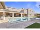 Enjoy this backyard view featuring a pool, covered patio, and well-manicured turf at 2285 E Chandler Heights Rd, Chandler, AZ 85249