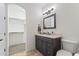 Well-lit bathroom features dark cabinets, a square mirror, and neutral accents at 2285 E Chandler Heights Rd, Chandler, AZ 85249