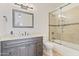 Bathroom featuring a vanity, large framed mirror, and tiled shower with glass doors at 2285 E Chandler Heights Rd, Chandler, AZ 85249