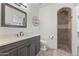 Stylish bathroom with stone floors, dark wood cabinets and a tiled shower at 2285 E Chandler Heights Rd, Chandler, AZ 85249