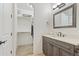 Bathroom showcasing a vanity, framed mirror, and walk-in closet in the background at 2285 E Chandler Heights Rd, Chandler, AZ 85249