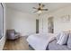 Spacious bedroom with a ceiling fan, hardwood floors, and large windows at 2285 E Chandler Heights Rd, Chandler, AZ 85249