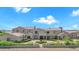 Elegant two-story home with a circular driveway, lush landscaping, and a private gated entrance at 2285 E Chandler Heights Rd, Chandler, AZ 85249