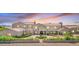Elegant two-story home with a circular driveway, lush landscaping, and a private gated entrance at 2285 E Chandler Heights Rd, Chandler, AZ 85249
