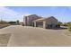 Spacious home exterior with a tan facade, tile roof and brick driveway at 2285 E Chandler Heights Rd, Chandler, AZ 85249
