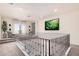 Bright hallway features wrought iron railing, neutral carpet, and stylish decor at 2285 E Chandler Heights Rd, Chandler, AZ 85249