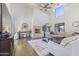 Bright living room with tall windows, a fireplace, hardwood floors, and comfortable couches at 2285 E Chandler Heights Rd, Chandler, AZ 85249
