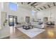 Comfortable living room with large windows, a stone fireplace, hardwood floors, and a stylish rug at 2285 E Chandler Heights Rd, Chandler, AZ 85249