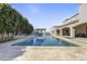 A luxurious pool area with an outdoor cabana, water feature, and beautiful landscaping at 2285 E Chandler Heights Rd, Chandler, AZ 85249