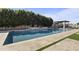 Backyard pool featuring travertine pavers, pergola with shade, water feature, and mature trees at 2285 E Chandler Heights Rd, Chandler, AZ 85249