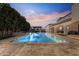 A luxurious pool area with an outdoor cabana, water feature, and beautiful landscaping at 2285 E Chandler Heights Rd, Chandler, AZ 85249