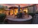 Entertain under the pergola on the home's patio, set in a desert landscaped backyard at 27654 N 125Th Dr, Peoria, AZ 85383