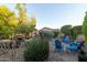 The covered patio area is surrounded by mature trees and desert landscaping at 27654 N 125Th Dr, Peoria, AZ 85383