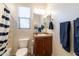 Cozy bathroom with a single sink vanity, a tub-shower, and classic decor at 27654 N 125Th Dr, Peoria, AZ 85383