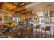 Open-concept clubhouse with modern lighting, stylish furnishings, and kitchen at 27654 N 125Th Dr, Peoria, AZ 85383
