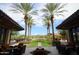 Beautifully landscaped courtyard with palm trees and seating, perfect for relaxation and outdoor gatherings at 27654 N 125Th Dr, Peoria, AZ 85383