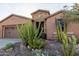 Charming home exterior with desert landscaping, showcasing native cacti and a stone facade entry at 27654 N 125Th Dr, Peoria, AZ 85383