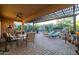 Relax on the covered patio in this home, featuring luxurious seating and desert landscaping at 27654 N 125Th Dr, Peoria, AZ 85383