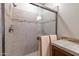 Walk-in shower featuring neutral tile, a glass door, and brushed nickel fixtures at 27654 N 125Th Dr, Peoria, AZ 85383