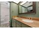 Bathroom with double sinks, wood countertop, and shower over tub at 2844 W Christy Dr, Phoenix, AZ 85029