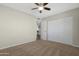 Cozy bedroom with neutral walls, carpet, ceiling fan, closet, and easy access to the adjacent rooms at 2844 W Christy Dr, Phoenix, AZ 85029